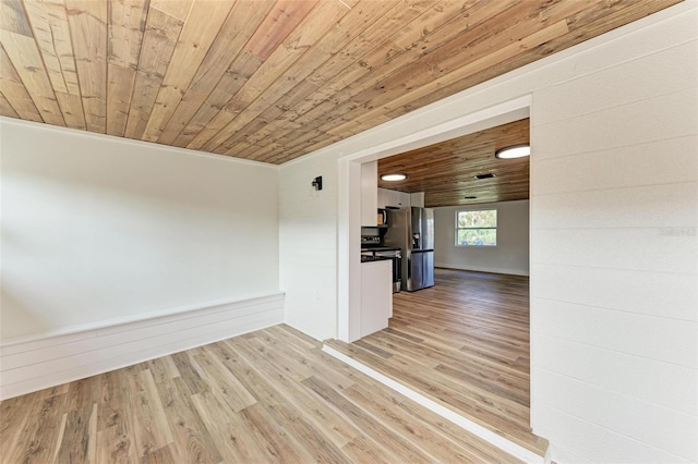 interior space with wooden walls, light hardwood / wood-style flooring, wood ceiling, and ornamental molding