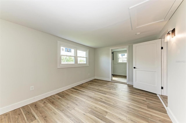 empty room with light hardwood / wood-style flooring