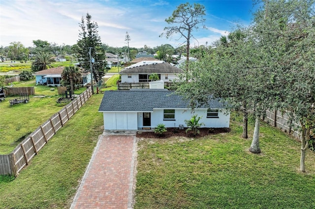 view of front of home with a front yard and a garage