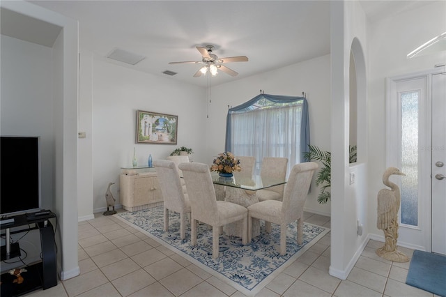 tiled dining room featuring ceiling fan