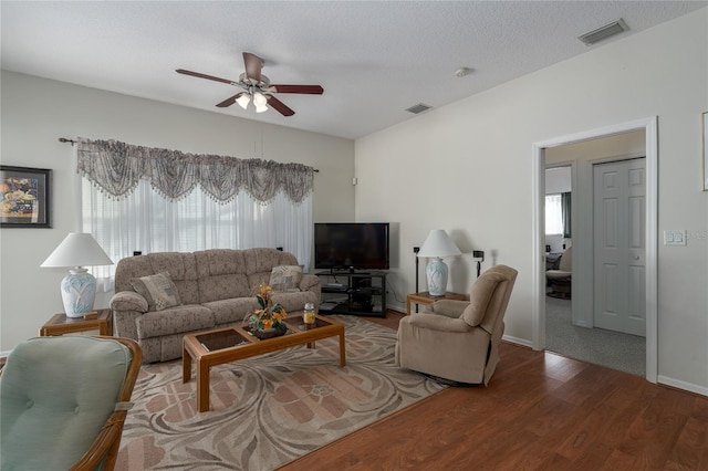 4569 35th Avenue Cir E, Palmetto, FL 34221 - living room featuring a ceiling fan, wood finished floors, and baseboards