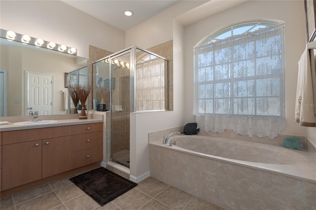 bathroom with tile patterned floors, vanity, and independent shower and bath