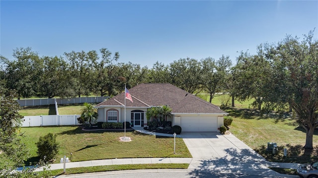 single story home featuring a front lawn and a garage