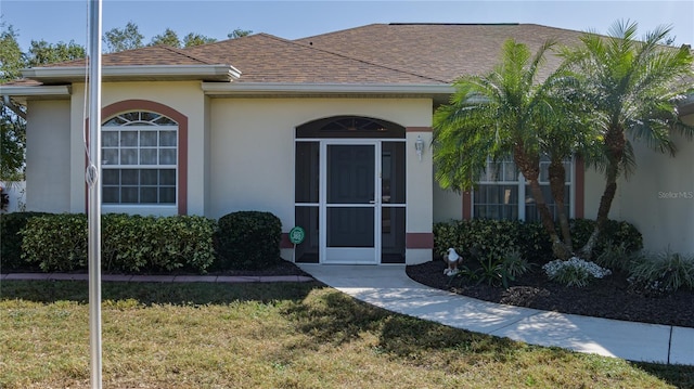 doorway to property with a yard