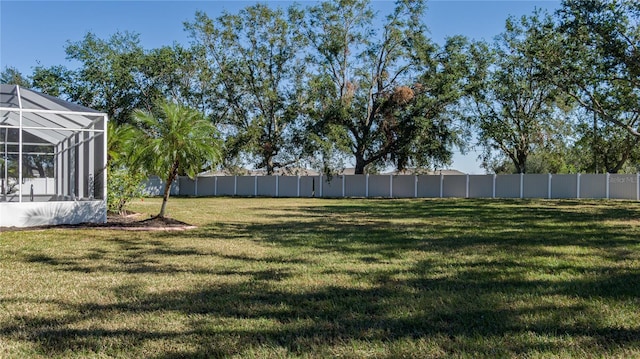 view of yard with glass enclosure