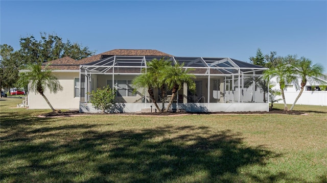 4569 35th Avenue Cir E, Palmetto, FL 34221 - rear view of house featuring a lawn, glass enclosure, and stucco siding
