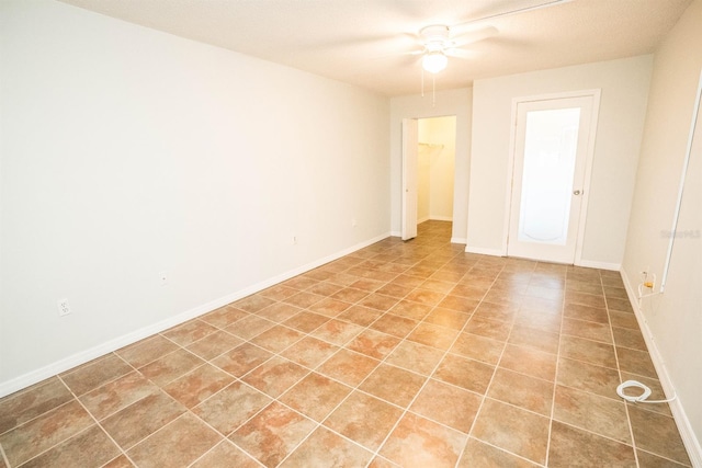 tiled spare room featuring ceiling fan and a textured ceiling