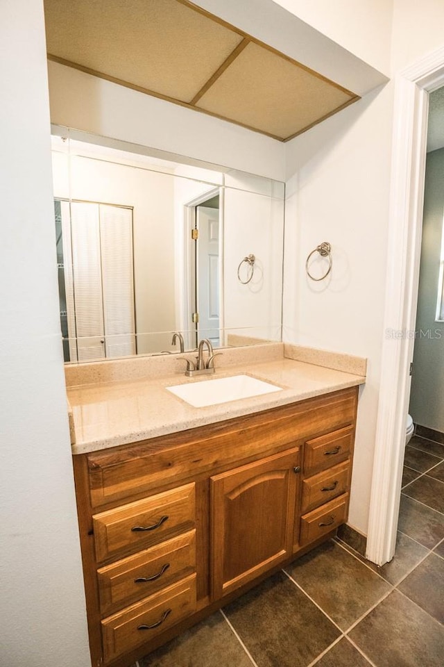 bathroom featuring tile patterned floors, vanity, and toilet