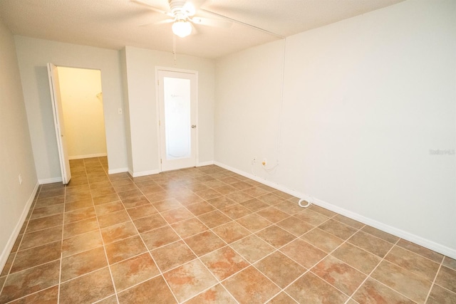 unfurnished room featuring tile patterned flooring, a textured ceiling, and ceiling fan