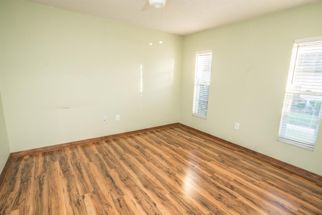 unfurnished room with ceiling fan and hardwood / wood-style floors