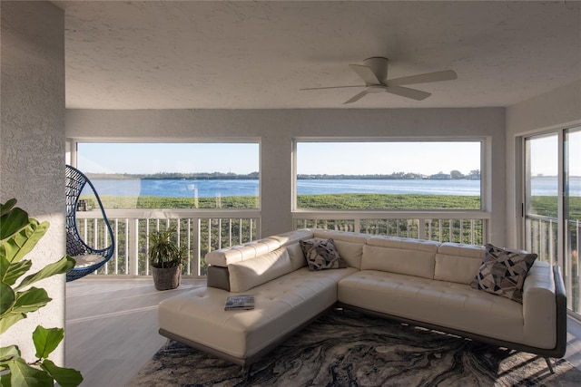 interior space featuring ceiling fan and a water view