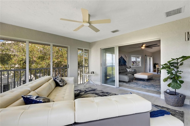 living room with ceiling fan, vaulted ceiling, and hardwood / wood-style flooring