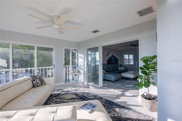 sunroom with ceiling fan and a healthy amount of sunlight