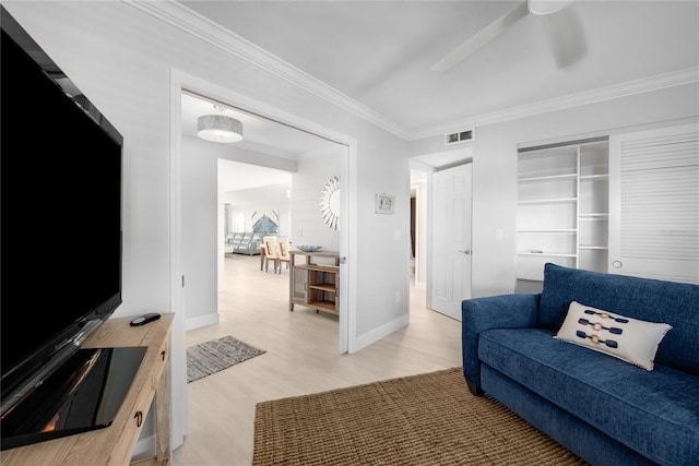 living room featuring crown molding, ceiling fan, and hardwood / wood-style flooring