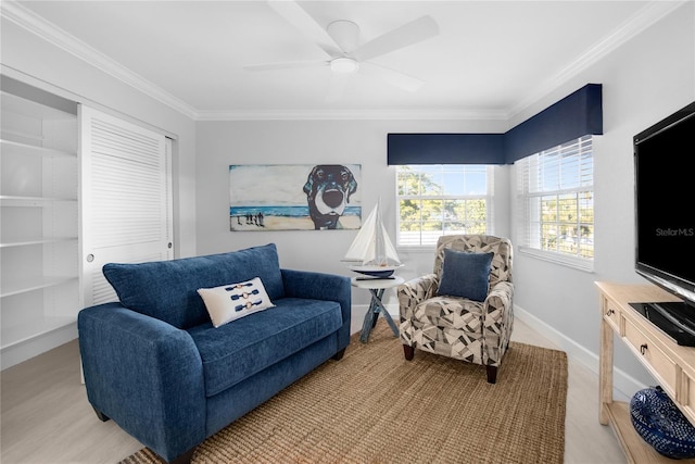 living room with ceiling fan, light wood-type flooring, and crown molding