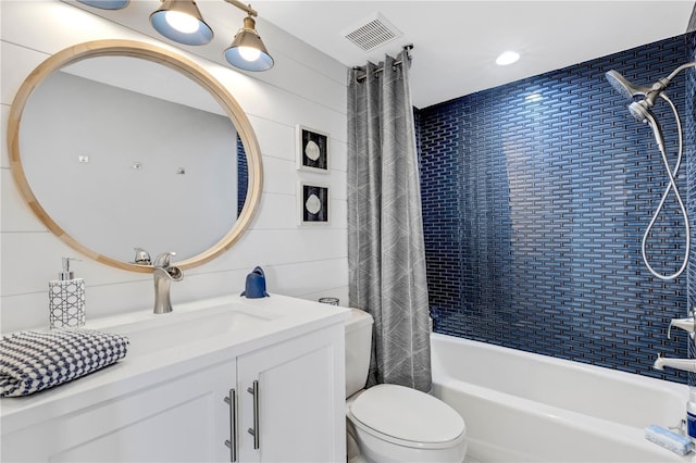 full bathroom with vanity, wooden walls, shower / bathtub combination with curtain, and toilet