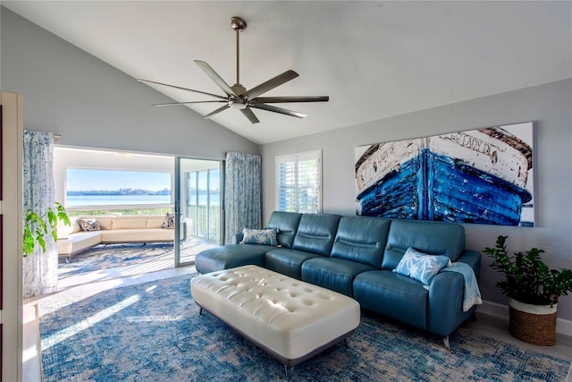 living room featuring ceiling fan, hardwood / wood-style floors, and vaulted ceiling