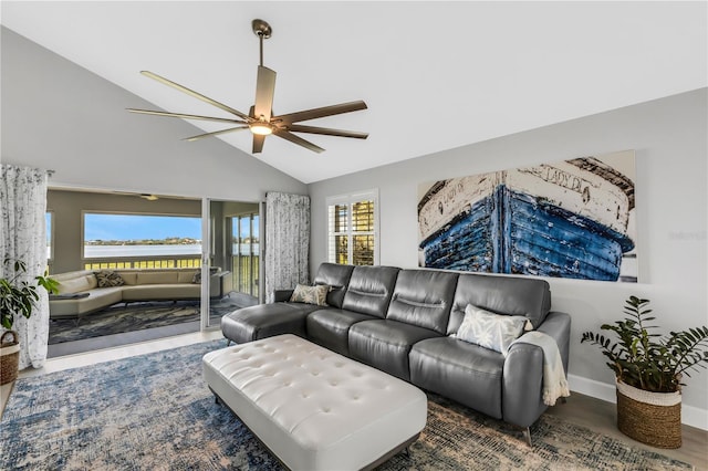 living room with hardwood / wood-style floors, ceiling fan, and lofted ceiling