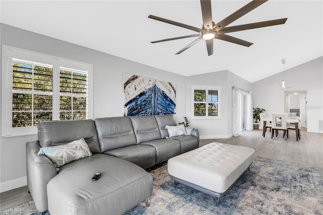 living room with hardwood / wood-style floors, vaulted ceiling, a wealth of natural light, and ceiling fan