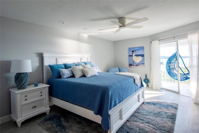 bedroom featuring ceiling fan, dark wood-type flooring, and access to outside