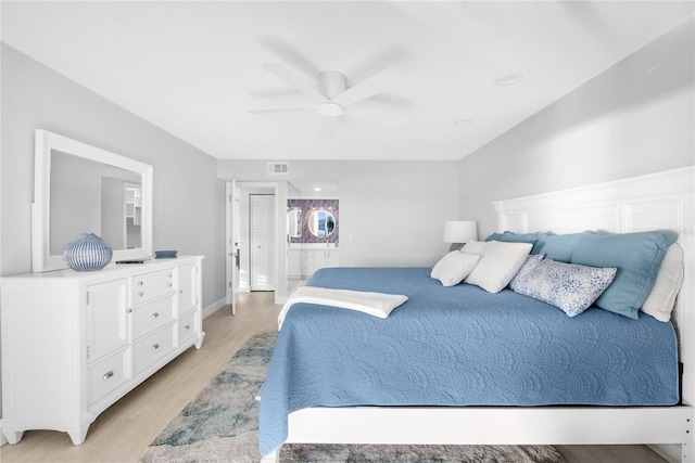 bedroom featuring ceiling fan, light hardwood / wood-style floors, and ensuite bathroom