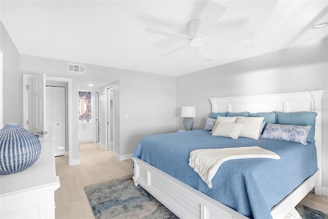 bedroom featuring ceiling fan, a closet, and light wood-type flooring