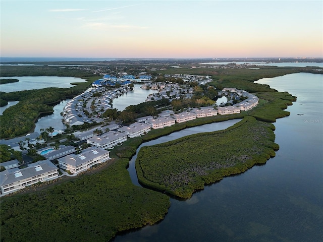 aerial view at dusk with a water view