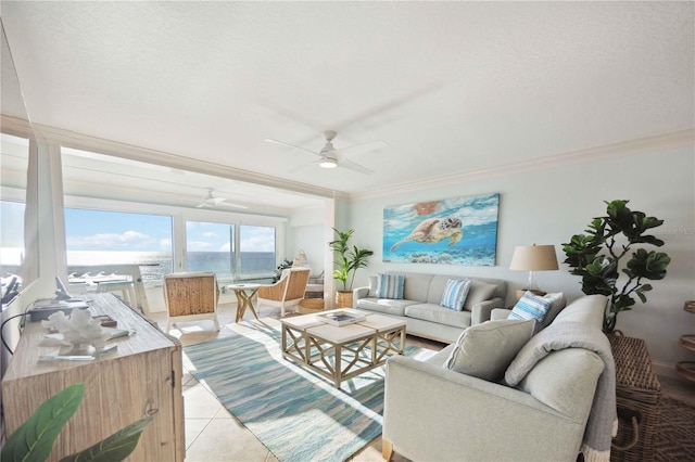 living room featuring a water view, ceiling fan, light tile patterned flooring, and crown molding