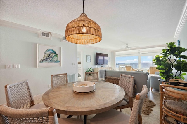 6140 Midnight Pass Rd Unit 407, Sarasota, FL 34242 - tiled dining space with a textured ceiling, ceiling fan, and ornamental molding
