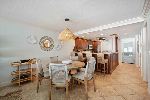 6140 Midnight Pass Rd Unit 407, Sarasota, FL 34242 - tiled dining space featuring ornamental molding and a textured ceiling