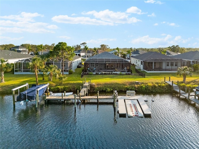 view of dock with a lawn, glass enclosure, and a water view