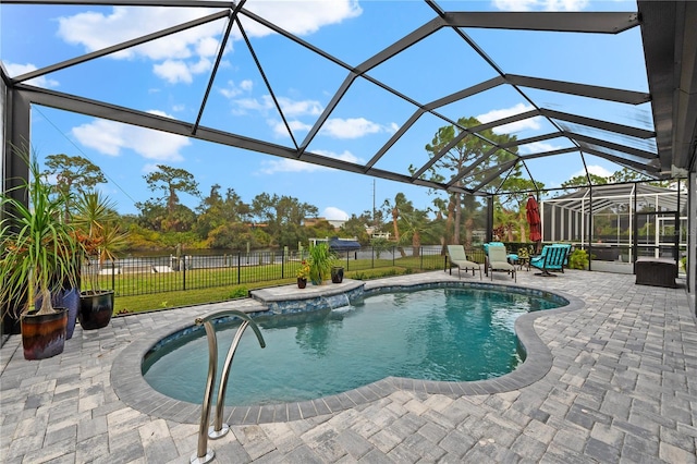 view of swimming pool with a yard, a patio, and a lanai