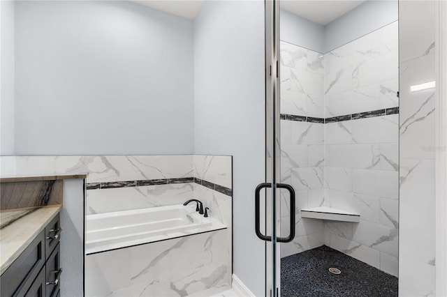 bathroom featuring vanity and shower with separate bathtub