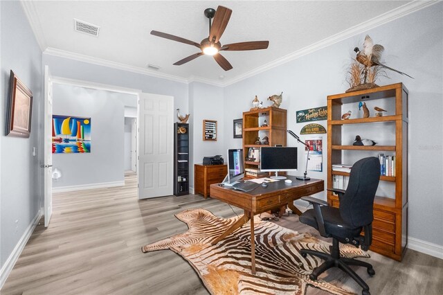 office space featuring ceiling fan, ornamental molding, and light hardwood / wood-style flooring