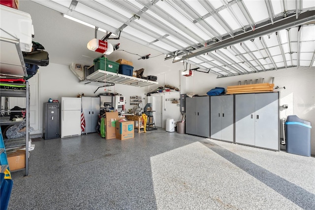 garage featuring white fridge and a garage door opener