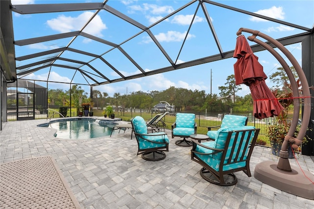 view of swimming pool with glass enclosure and a patio area