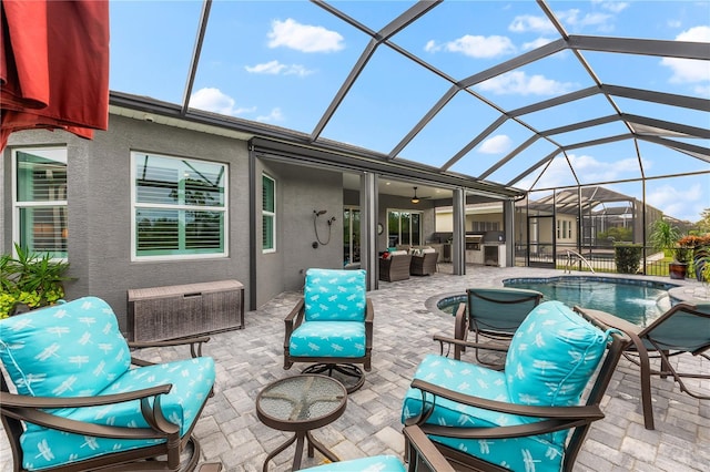 view of patio featuring a lanai, outdoor lounge area, and ceiling fan