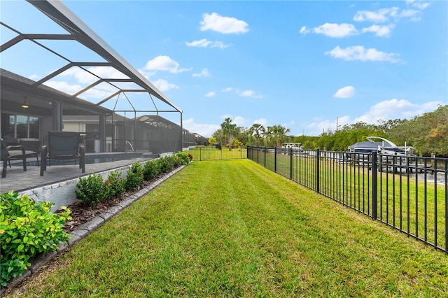 view of yard featuring a patio and glass enclosure