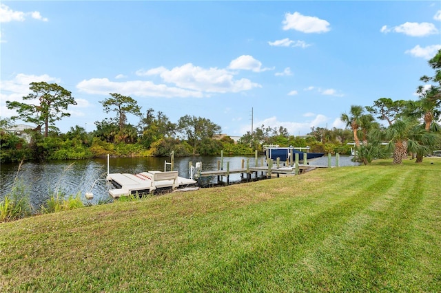 dock area featuring a lawn and a water view