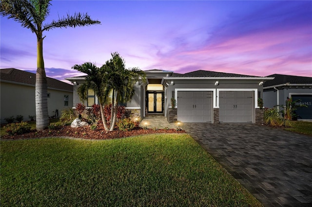 view of front of house with a lawn and a garage