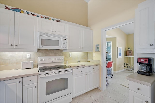 kitchen featuring white cabinetry and white appliances