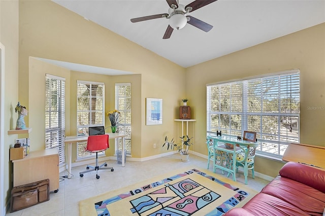 office with plenty of natural light, light tile patterned flooring, and vaulted ceiling