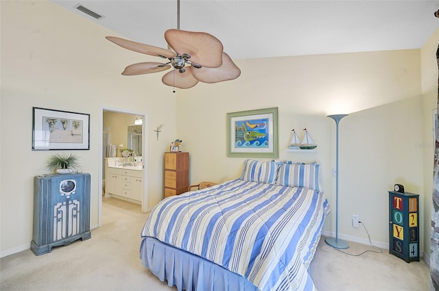 bedroom featuring ceiling fan, ensuite bathroom, light carpet, and high vaulted ceiling