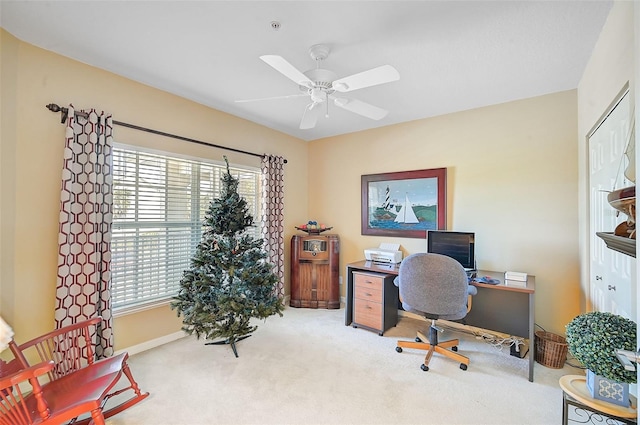 carpeted home office with ceiling fan