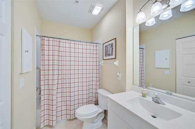 bathroom featuring tile patterned flooring, vanity, and toilet