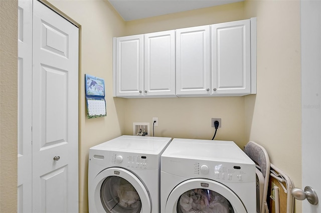 laundry area featuring cabinets and washing machine and dryer