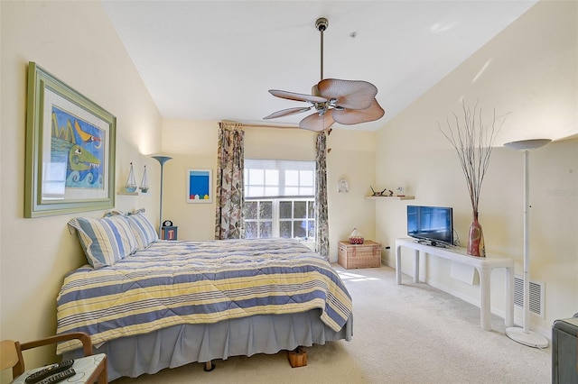 carpeted bedroom with ceiling fan and vaulted ceiling