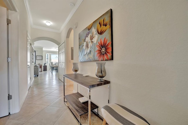 hall with light tile patterned floors and ornamental molding