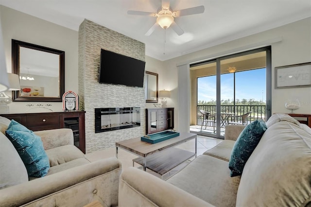 tiled living room with a stone fireplace, ceiling fan, and crown molding