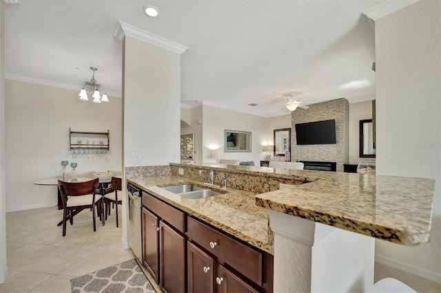 kitchen with sink, dishwasher, light stone counters, ceiling fan with notable chandelier, and ornamental molding